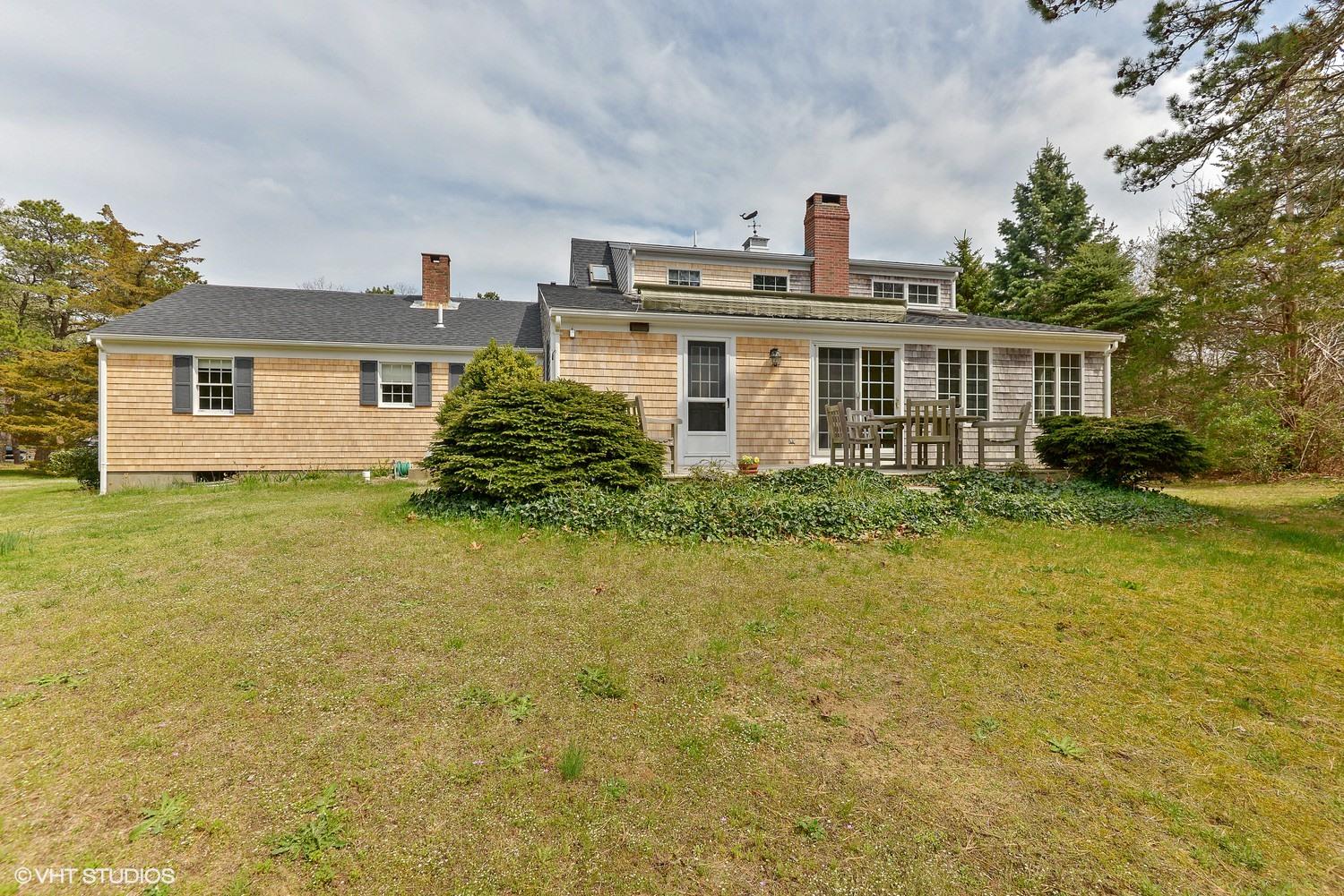 2055 Bridge Road Eastham, MA 02642 - Photo 15 of 22 a front view of house with yard and trees in the background