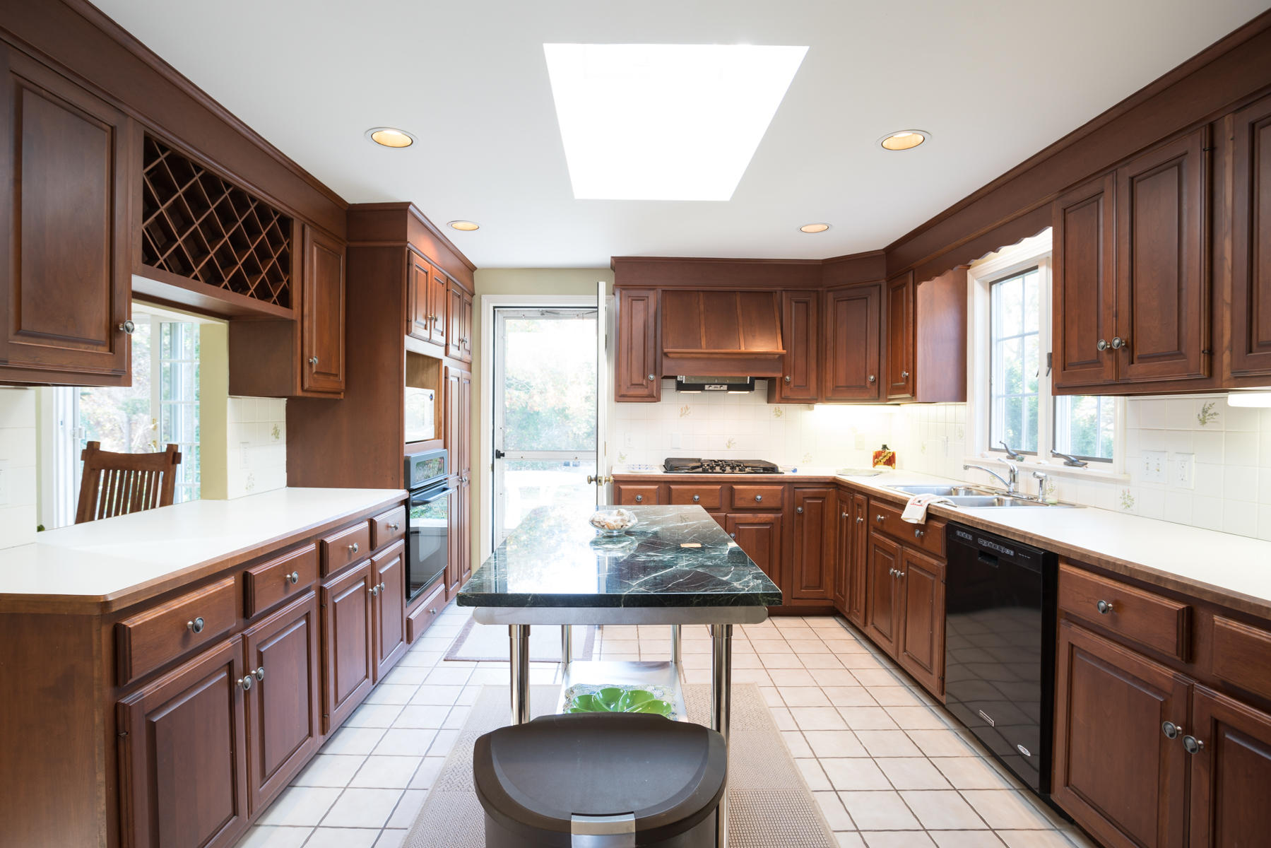 2055 Bridge Road Eastham, MA 02642 - Photo 6 of 22 a kitchen with stainless steel appliances granite countertop a stove a sink dishwasher and a refrigerator with wooden cabinets