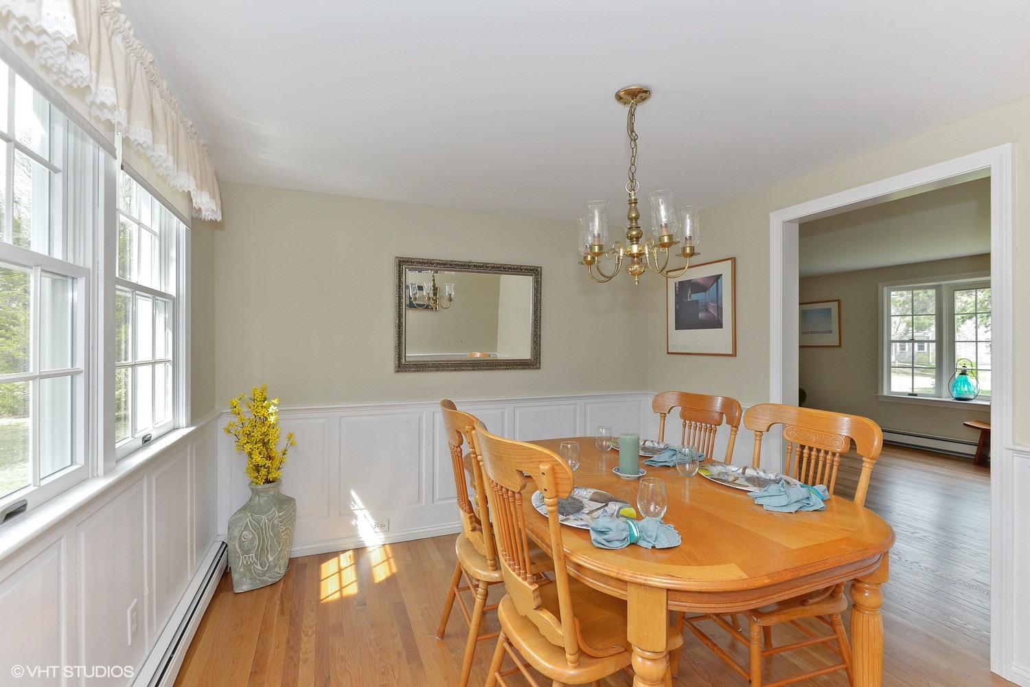 2055 Bridge Road Eastham, MA 02642 - Photo 7 of 22 a dining room with furniture a chandelier and wooden floor