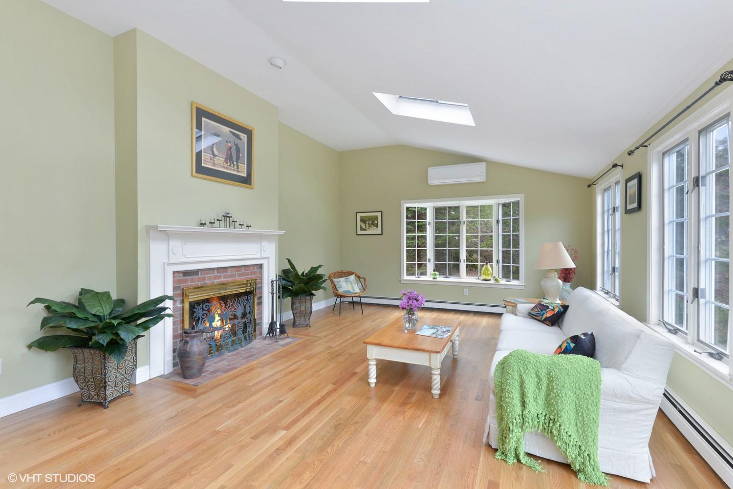 2055 Bridge Road Eastham, MA 02642 - Photo 9 of 22 a living room with furniture a fireplace and a potted plant