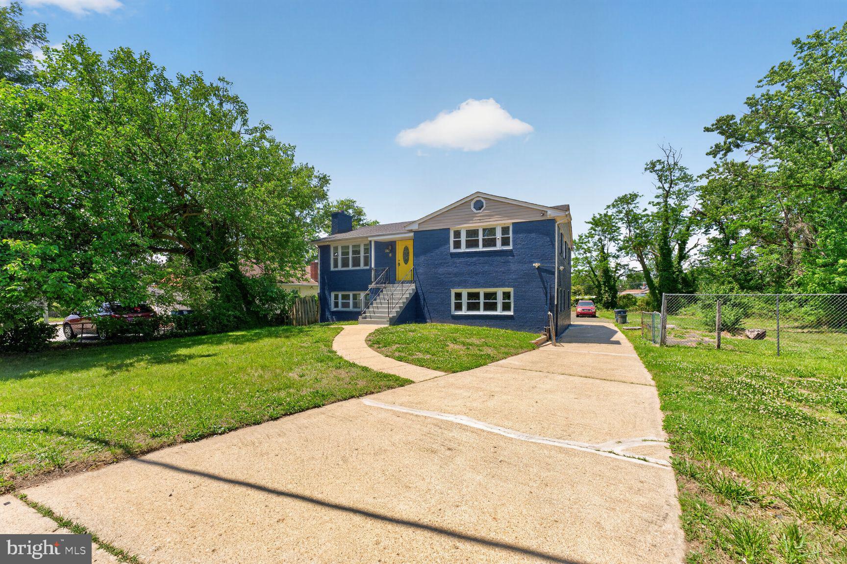 7205 Livingston Road Oxon Hill, MD 20745 - Photo 2 of 25 Charming blue home with lush greenery.