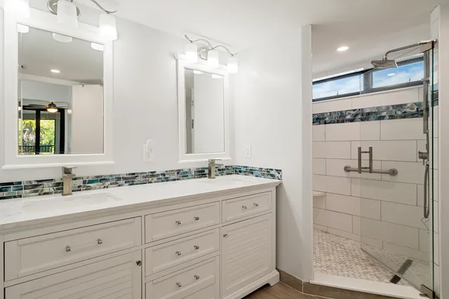 a bathroom with a shower sink and mirror