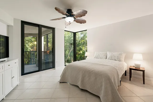 a large bed sitting in a bedroom next to a window