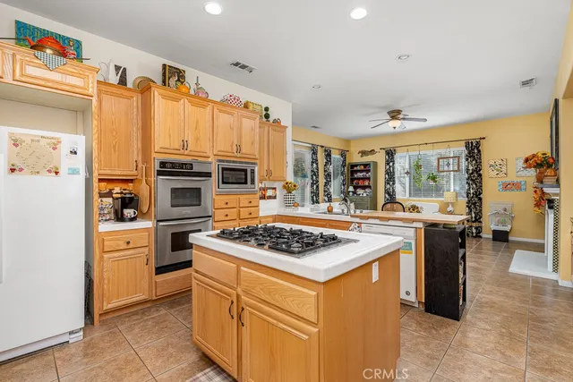 a kitchen that has a lot of cabinets in it and wooden floors