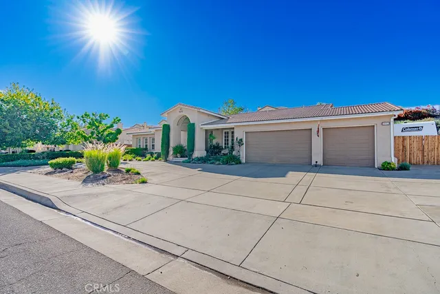 front view of a house with a bench and potted plants