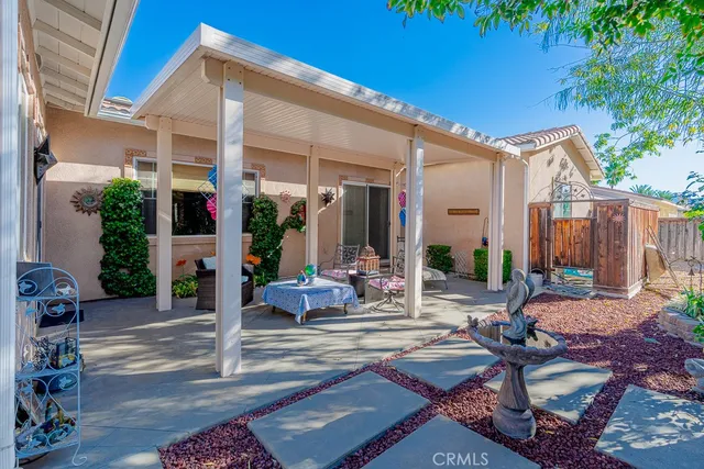 a view of a house with backyard and sitting area