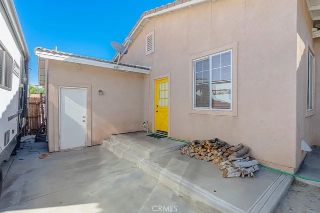 a view of a house with backyard and wooden fence