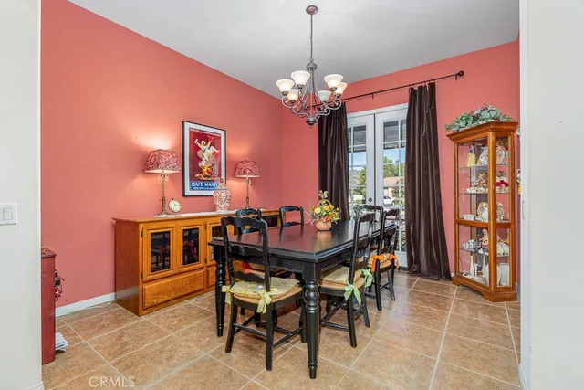 a living room with furniture a chandelier and a piano