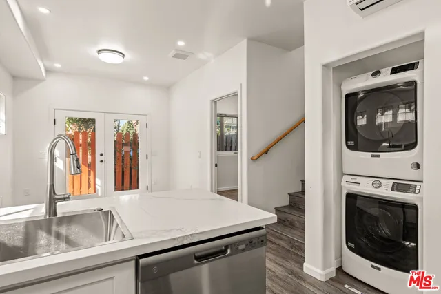 a kitchen with a sink a stove and cabinets