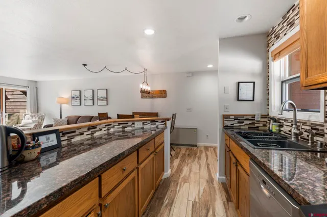 a kitchen with stainless steel appliances granite countertop a stove and a sink