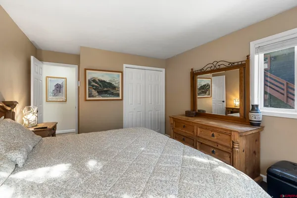 a bedroom with a bed and a dresser