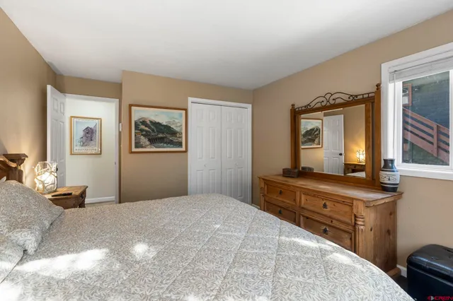 a bedroom with a bed and a dresser