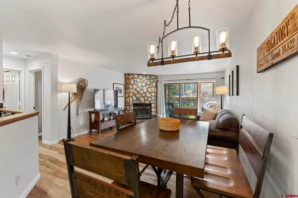 a view of a dining room with furniture and wooden floor
