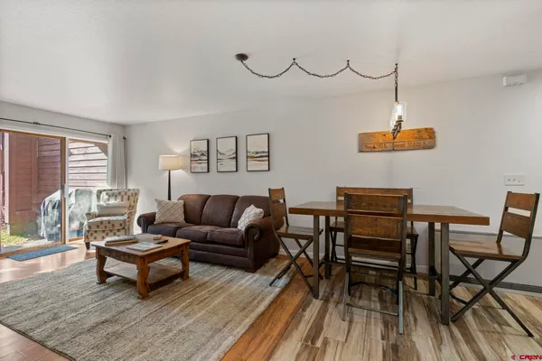 a living room with furniture and wooden floor