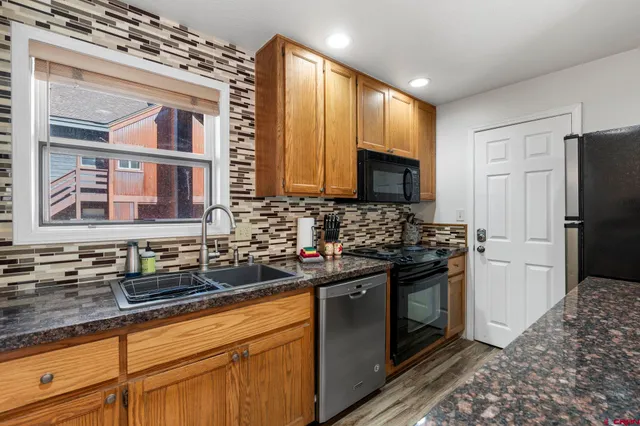 a kitchen with a sink stove and refrigerator