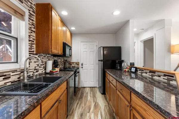 a kitchen with a sink stove top oven and microwave