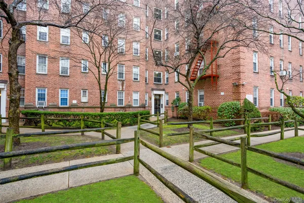 a view of a building with yard and green space
