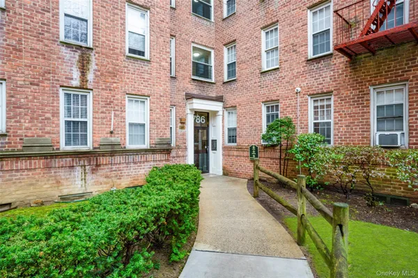 a view of a patio with couches chairs potted plants and water fountain