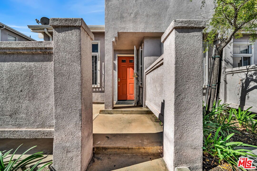 820 West Compton Boulevard, Unit 17 Compton, CA 90220 - Photo 2 of 50 a brick house with a large windows and flower plants