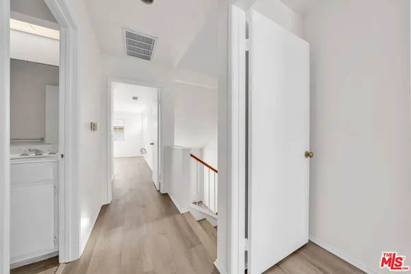 a view of a hallway with a wooden floor