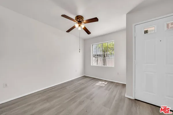 a view of room with hardwood floor and window