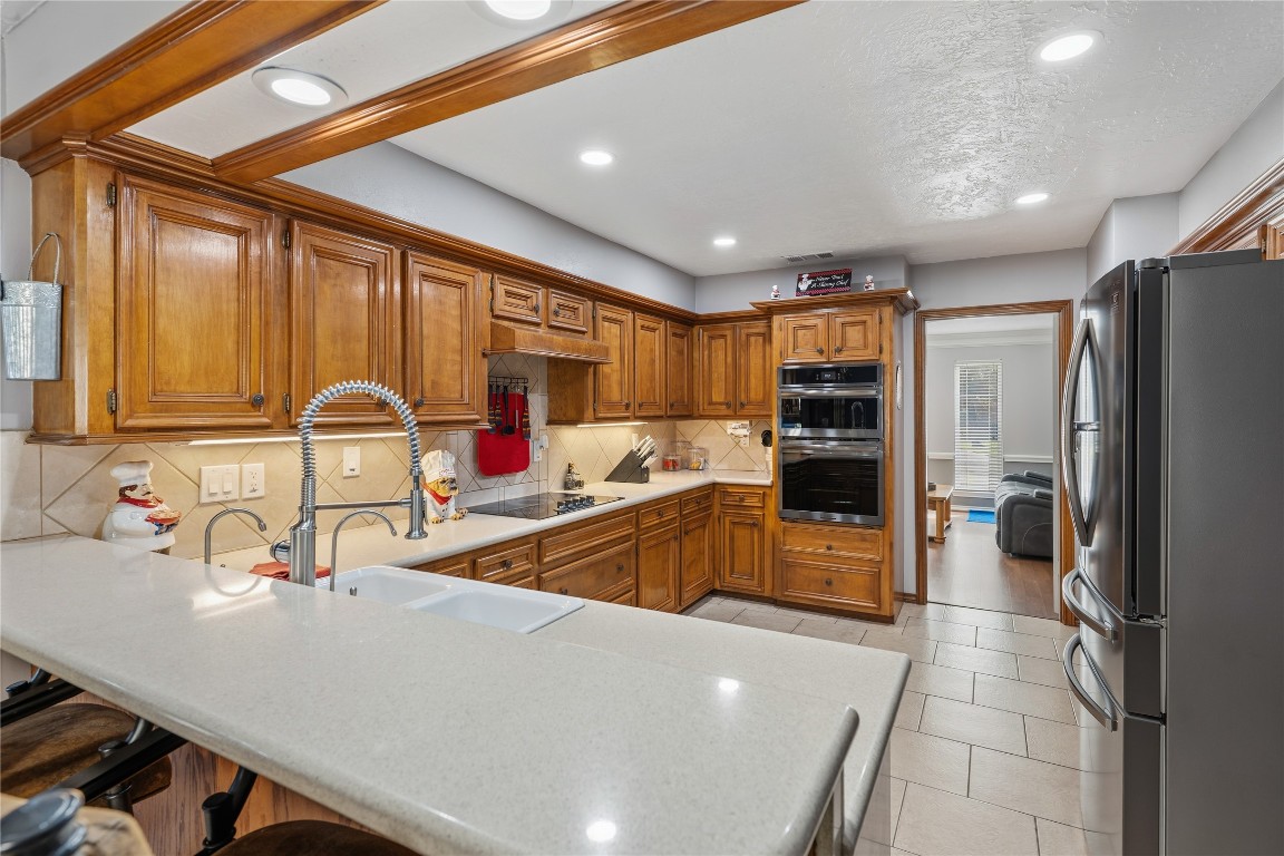 6618 Wimbledon Trail Road Spring, TX 77379 - Photo 11 of 43 Kitchen has a spacious layout with a built-in microwave, oven and stylish fixtures, offering a cozy yet functional cooking space.