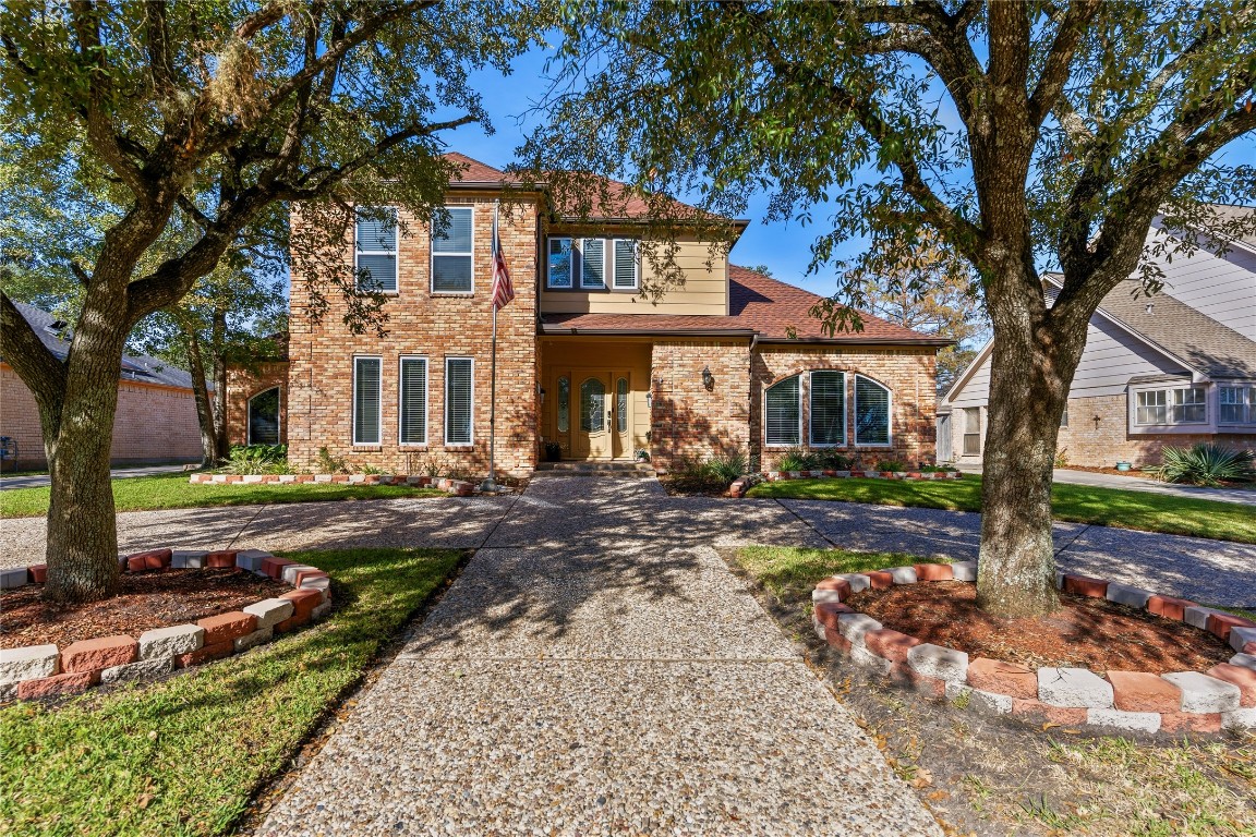6618 Wimbledon Trail Road Spring, TX 77379 - Photo 2 of 43 The property has a well-maintained lawn and a paved walkway leading to the door, creating an inviting curb appeal.