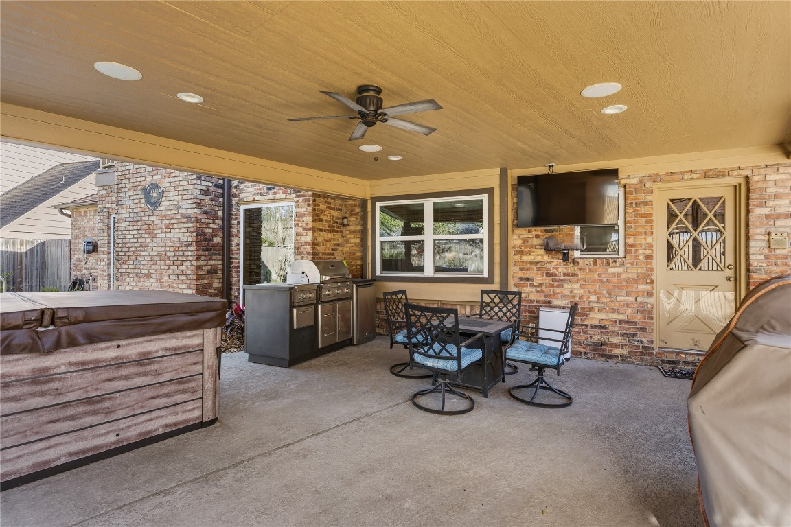 6618 Wimbledon Trail Road Spring, TX 77379 - Photo 35 of 43 Enjoy outdoor living year-round on this inviting covered patio, thoughtfully designed for both relaxation and entertaining. The space features a fully equipped outdoor kitchen, making it easy to grill, gather, and host with ease. With plenty of room for seating and dining, it’s the perfect extension of the home—ideal for weekend cookouts, game-day celebrations, or quiet evenings outdoors.