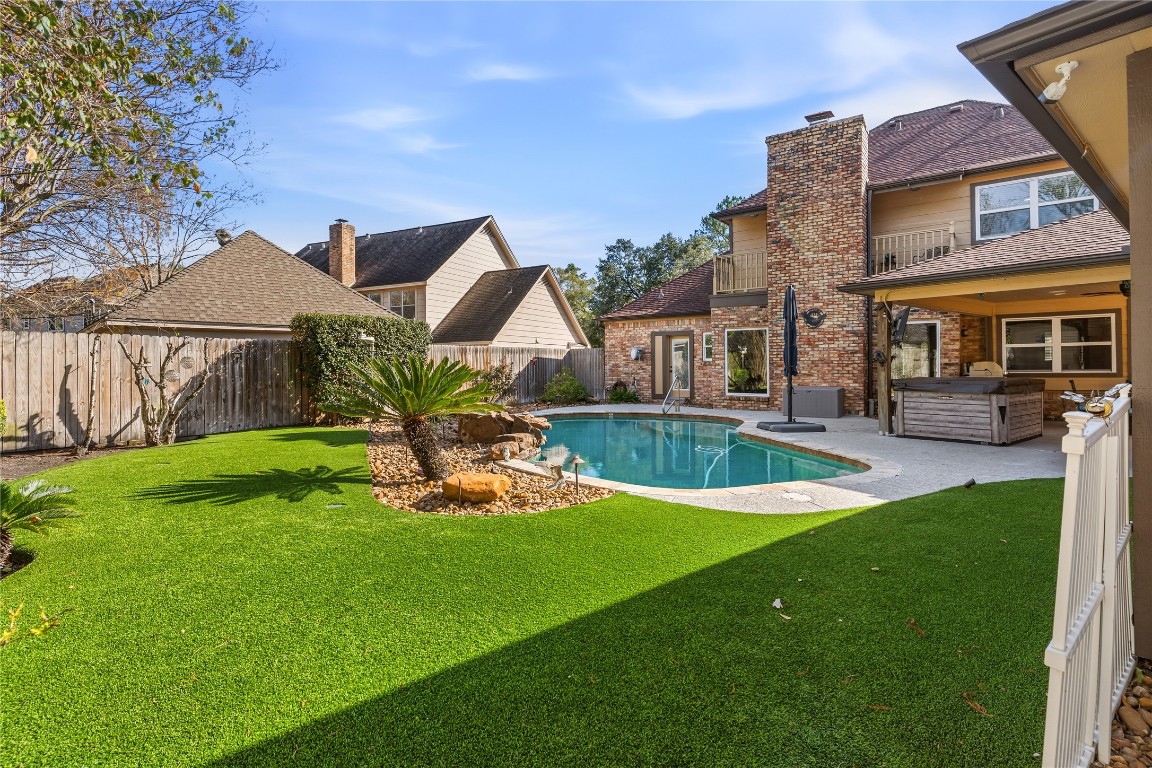 6618 Wimbledon Trail Road Spring, TX 77379 - Photo 36 of 43 This well-maintained backyard offers the perfect private retreat, featuring a sparkling pool, spacious patio area for lounging or entertaining, and lush artificial grass for low-maintenance beauty year-round. A built-in mosquito misting system enhances outdoor comfort, allowing you to enjoy the space with ease. Designed for both relaxation and gatherings, this outdoor oasis blends functionality, convenience, and effortless upkeep.