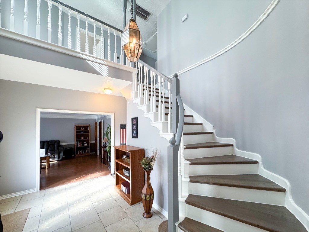 6618 Wimbledon Trail Road Spring, TX 77379 - Photo 6 of 43 A welcoming foyer with elegant tile flooring and a graceful curved staircase.