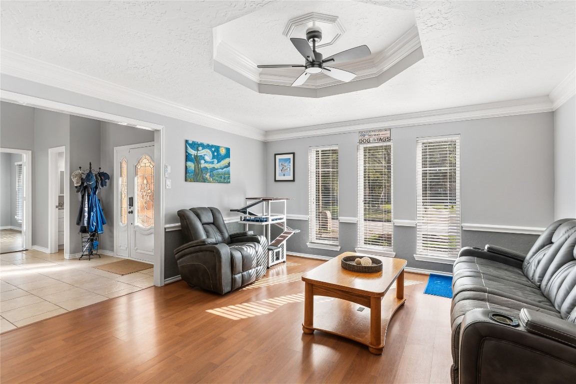 6618 Wimbledon Trail Road Spring, TX 77379 - Photo 8 of 43 Bright front room with wood floors, featuring a tray ceiling and a ceiling fan.