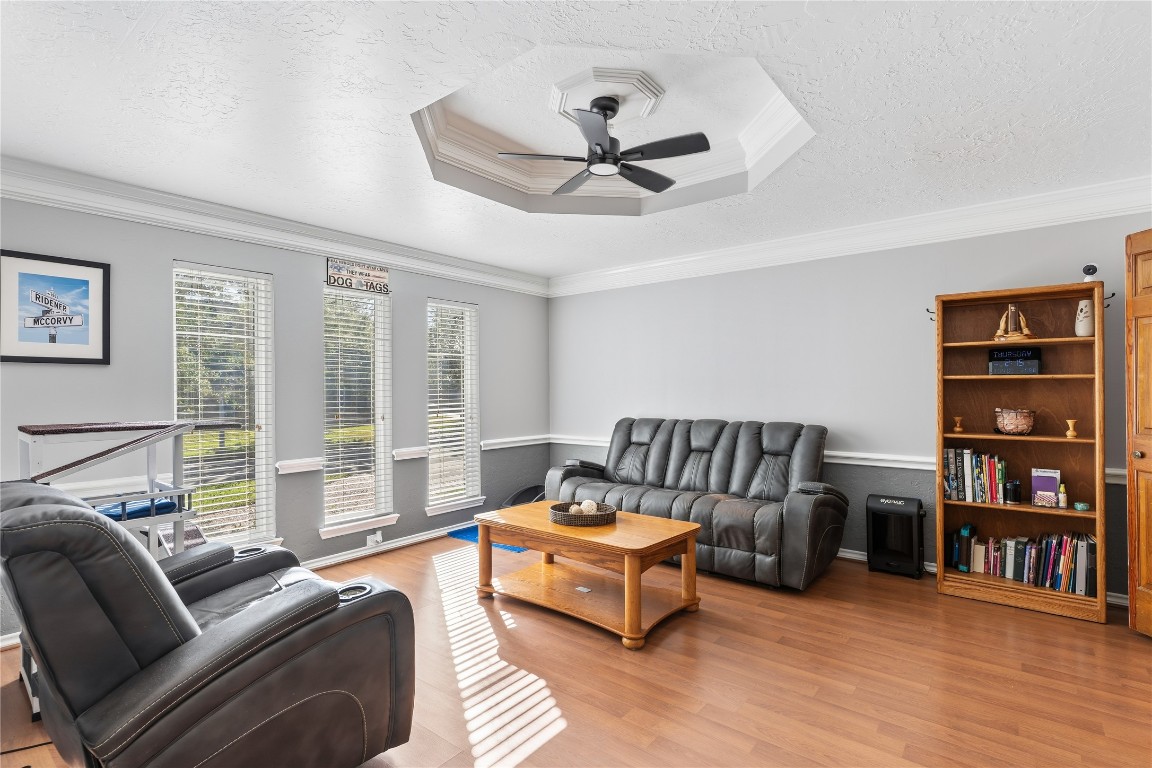 6618 Wimbledon Trail Road Spring, TX 77379 - Photo 10 of 43 Bright and inviting front room with large windows, wood flooring, and a ceiling fan. Currently furnished as a living room space but can be used as a dining room.