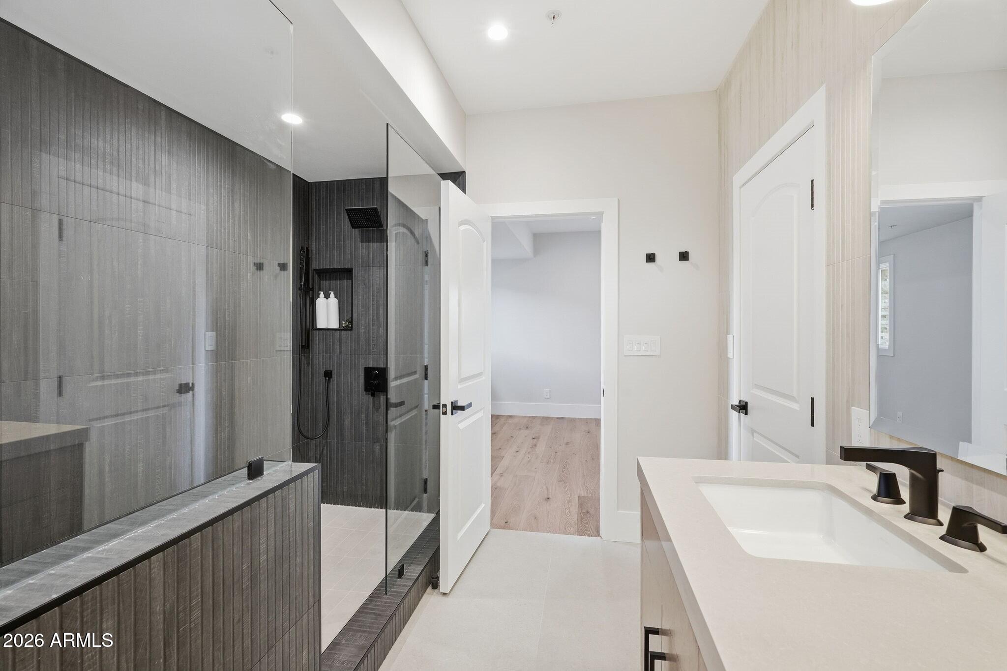 7475 East Gainey Ranch Road, Unit 7 Scottsdale, AZ 85258 - Photo 49 of 77 a bathroom with a sink and a large mirror