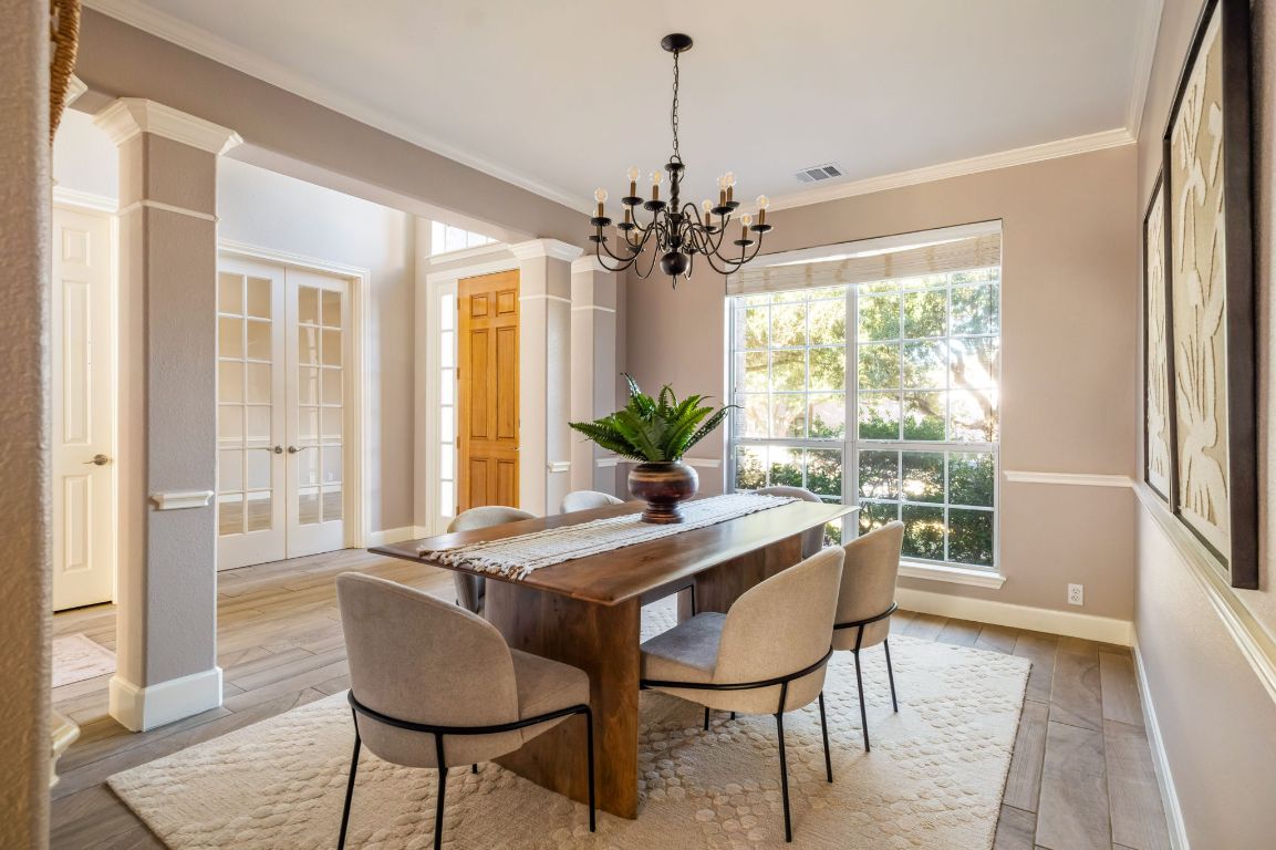 8101 Red Bird Court Austin, TX 78726 - Photo 15 of 33 a dining room with furniture window and wooden floor