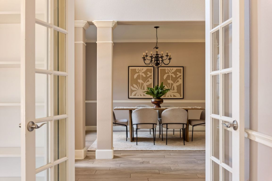 8101 Red Bird Court Austin, TX 78726 - Photo 17 of 33 a view of a hallway with wooden floor and dining room view