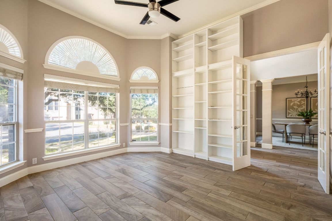 8101 Red Bird Court Austin, TX 78726 - Photo 18 of 33 an empty room with wooden floor and windows