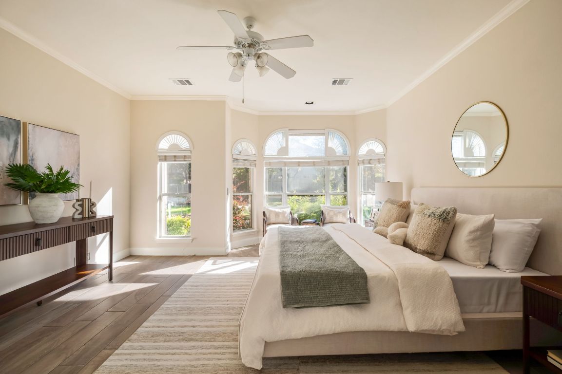 8101 Red Bird Court Austin, TX 78726 - Photo 20 of 33 a bedroom with a large bed and windows