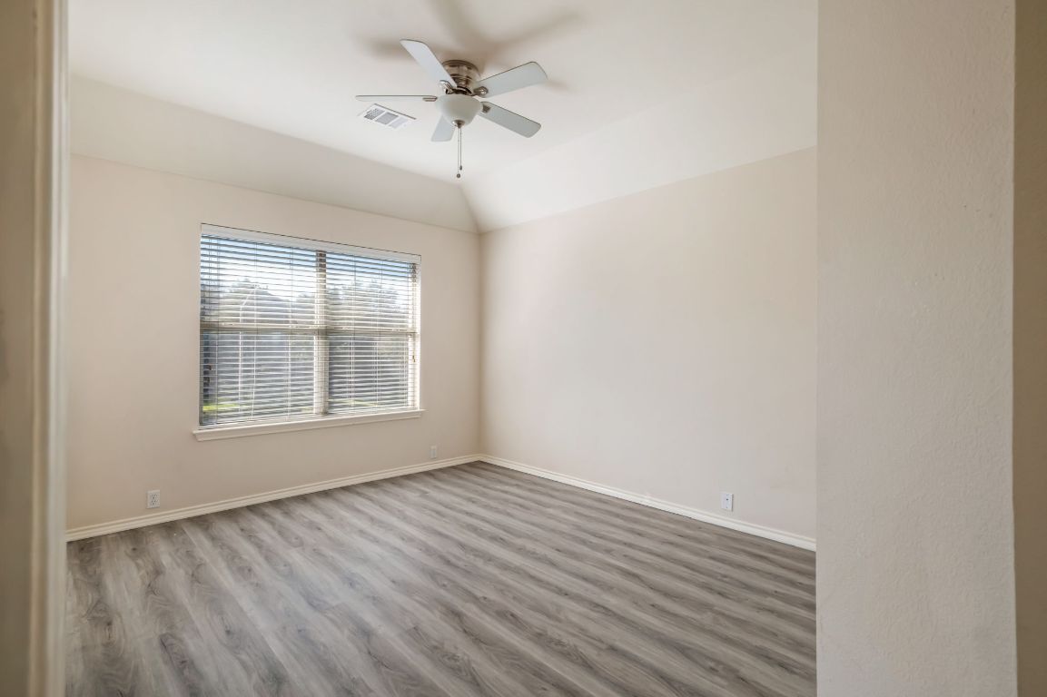 8101 Red Bird Court Austin, TX 78726 - Photo 25 of 33 a view of an empty room with wooden floor and a window