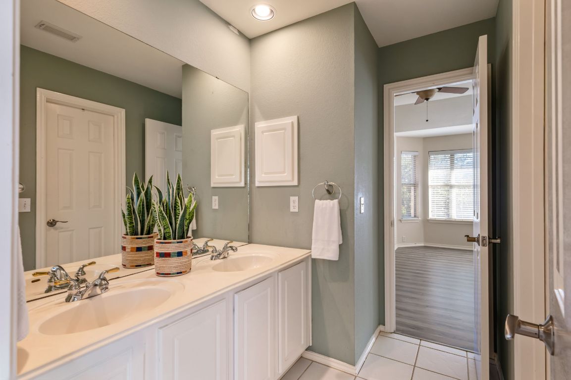 8101 Red Bird Court Austin, TX 78726 - Photo 26 of 33 a bathroom with a double vanity sink and mirror