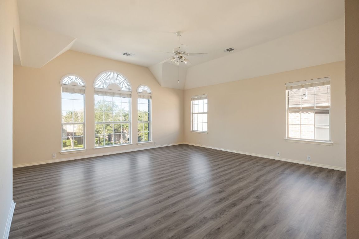 8101 Red Bird Court Austin, TX 78726 - Photo 27 of 33 an empty room with wooden floor and windows
