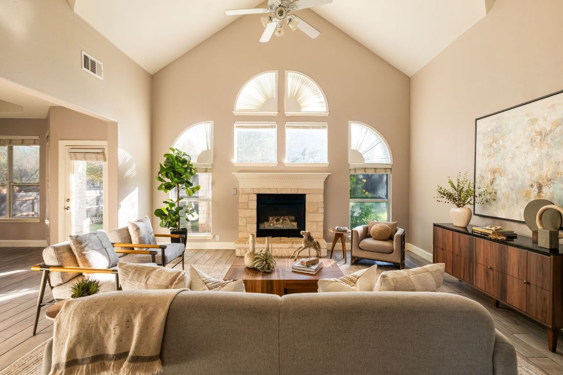 8101 Red Bird Court Austin, TX 78726 - Photo 3 of 33 a living room with furniture fireplace and a large window