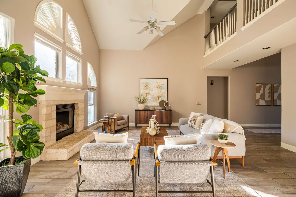 8101 Red Bird Court Austin, TX 78726 - Photo 4 of 33 a living room with furniture a fireplace and a potted plant