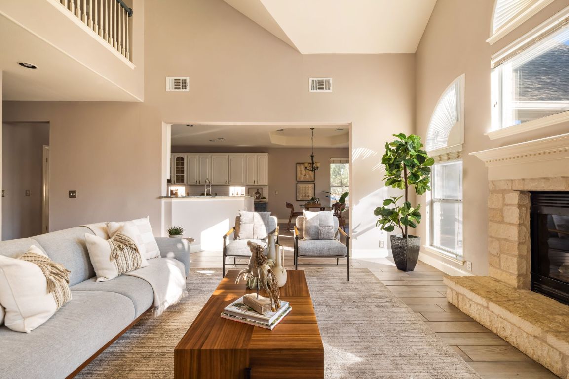 8101 Red Bird Court Austin, TX 78726 - Photo 7 of 33 a living room with furniture potted plant and a fireplace