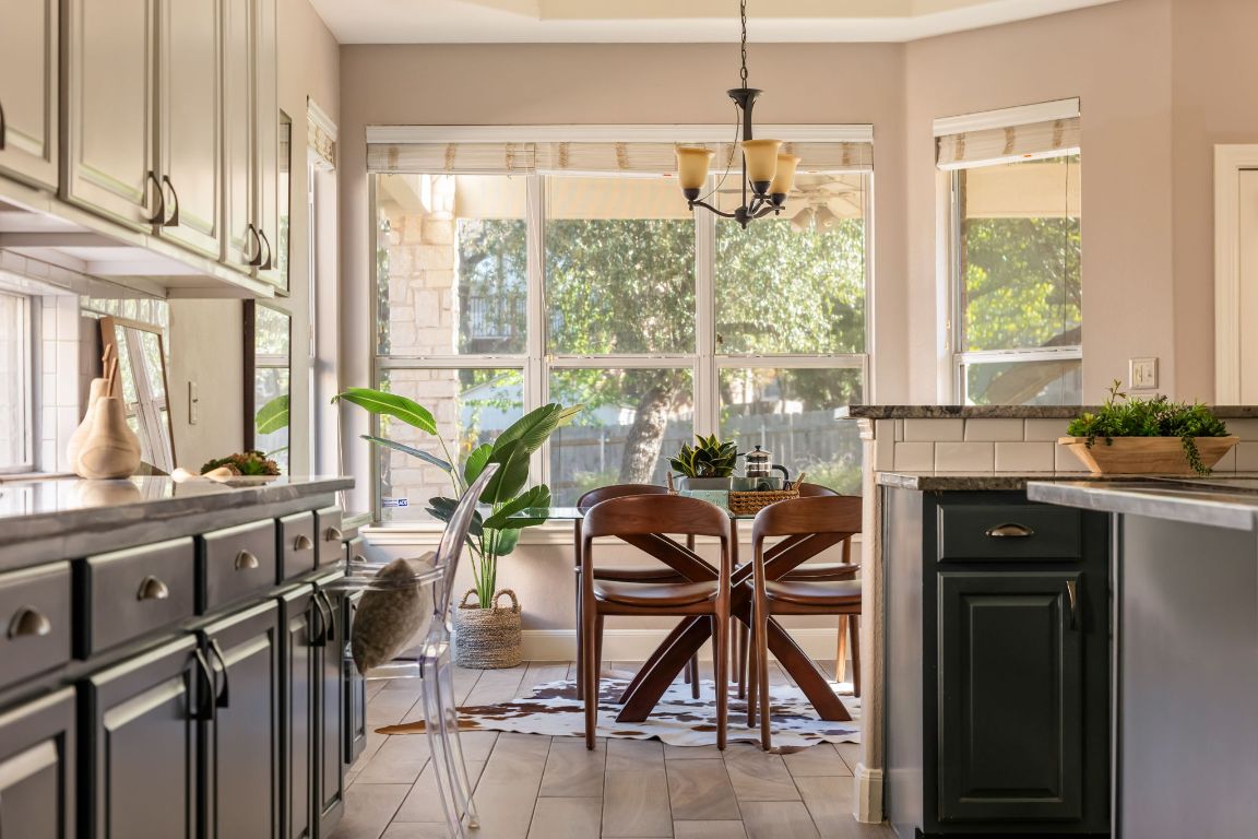 8101 Red Bird Court Austin, TX 78726 - Photo 9 of 33 a view of a dining room and livingroom with furniture wooden floor a chandelier