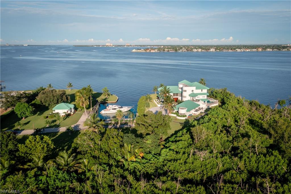 14040 Schultz Road Fort Myers, FL 33908 - Photo 1 of 48 Aerial view of property and surrounding area with a large body of water