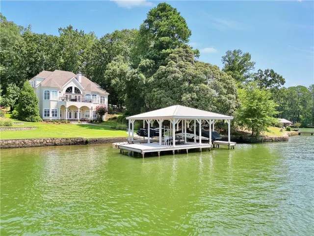 a dining room with furniture a chandelier and wooden floor