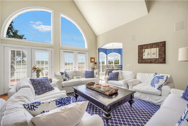 a front view of a house with garden and trees