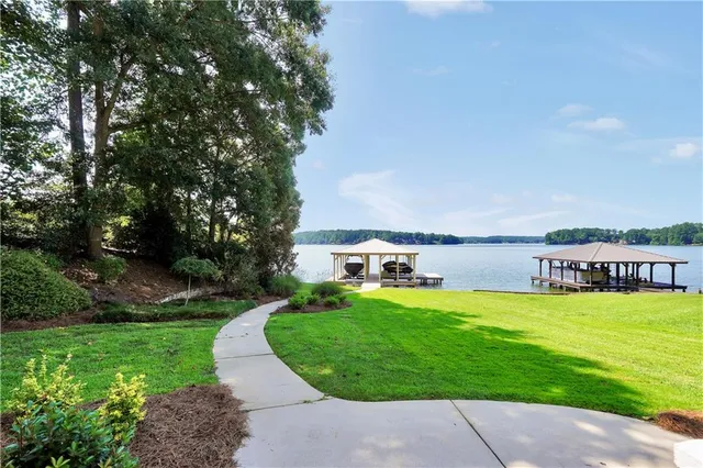 a view of a a dining room with furniture window and wooden floor