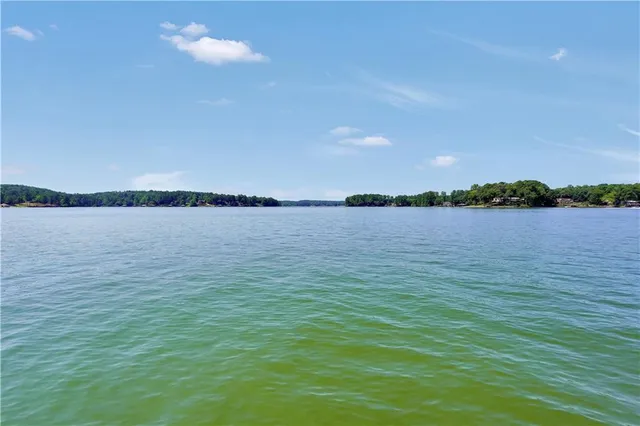a bedroom with a bed and a large window with the outer view