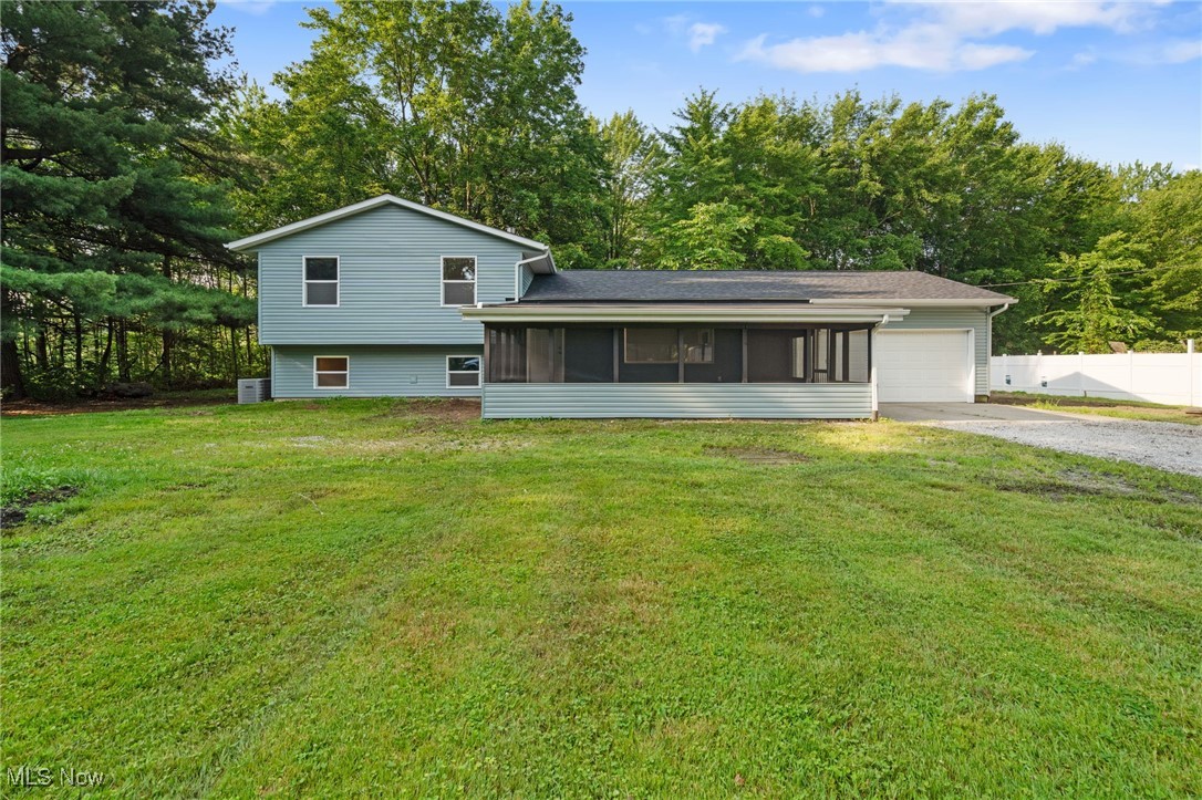 4232 Wilson Avenue Ravenna, OH 44266 - Photo 2 of 28 Back of house with a sunroom, driveway, and a garage